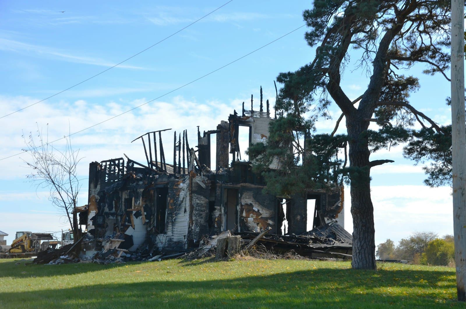 A burnt-out house with charred framing after a fire