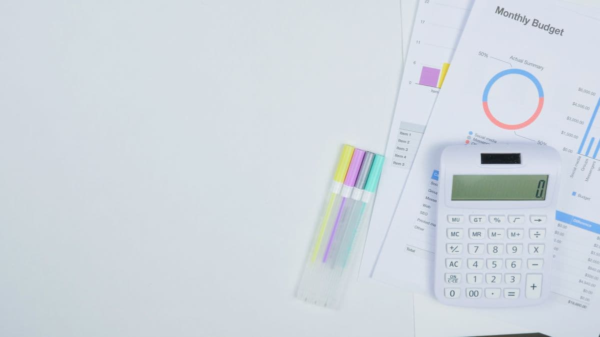 A calculator and budget documents on a desk