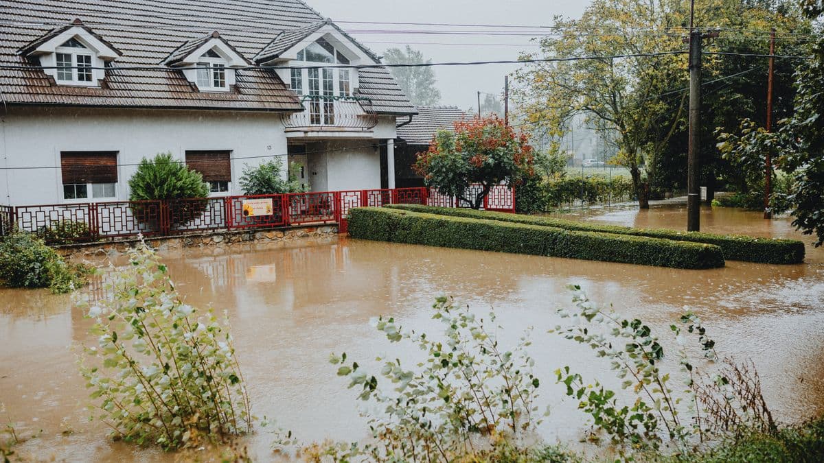 A suburban house surrounded by floodwater after heavy rain